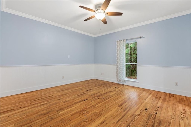 empty room with ornamental molding, light hardwood / wood-style flooring, and ceiling fan