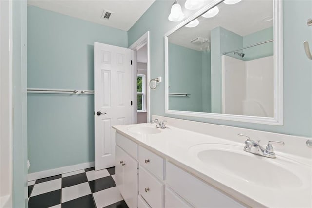 bathroom with vanity, toilet, and a shower