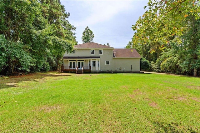 back of house with a wooden deck and a lawn