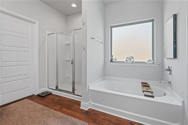 13077 Tara Point Dr, Mobile, AL 36695 - bathroom with a stall shower, a garden tub, wood finished floors, and carpet