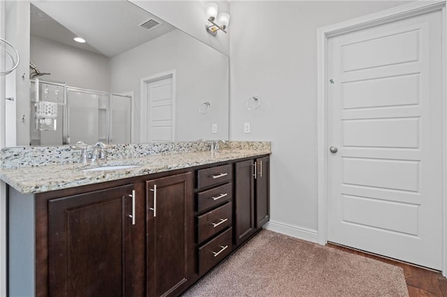 13077 Tara Point Dr, Mobile, AL 36695 - bathroom featuring double vanity, a stall shower, and baseboards