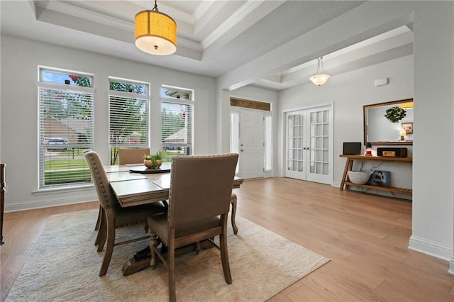 13077 Tara Point Dr, Mobile, AL 36695 - dining area featuring a raised ceiling, light wood-style floors, crown molding, and baseboards