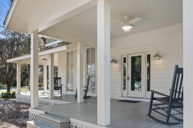 deck featuring covered porch and ceiling fan