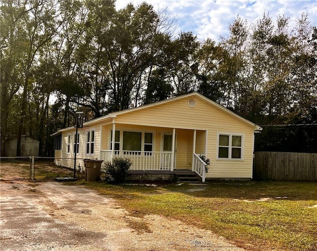 view of front of home with a porch and a front lawn