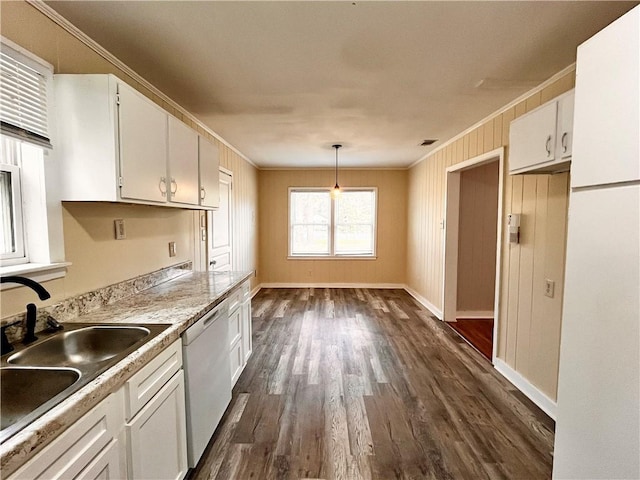 kitchen featuring white cabinets, ornamental molding, dishwashing machine, and hanging light fixtures