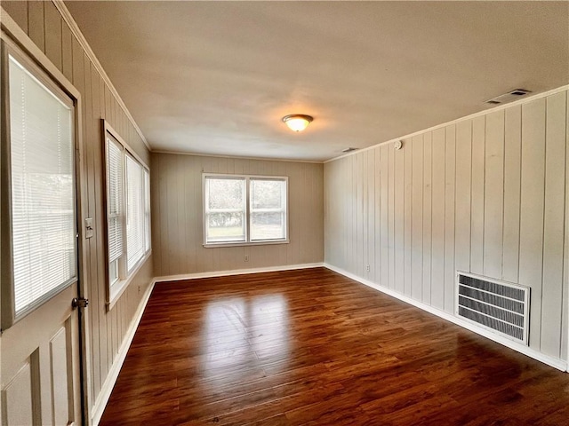 unfurnished room with crown molding and dark hardwood / wood-style floors