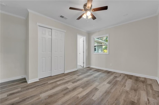 355 La Rose Dr, Mobile, AL 36609 - unfurnished bedroom featuring wood finished floors, baseboards, a closet, crown molding, and ceiling fan
