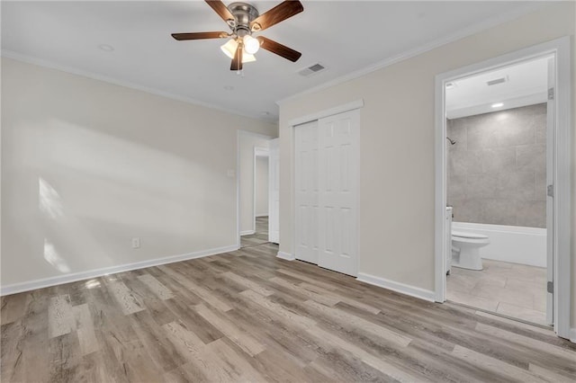 355 La Rose Dr, Mobile, AL 36609 - unfurnished bedroom featuring crown molding, a closet, wood finished floors, baseboards, and ensuite bathroom