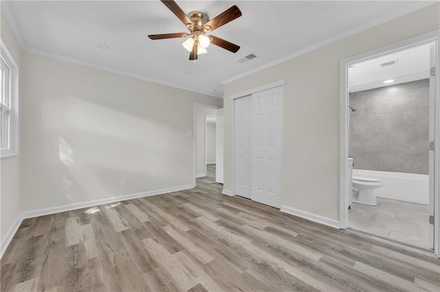 355 La Rose Dr, Mobile, AL 36609 - unfurnished bedroom featuring a closet, crown molding, wood finished floors, baseboards, and ensuite bathroom
