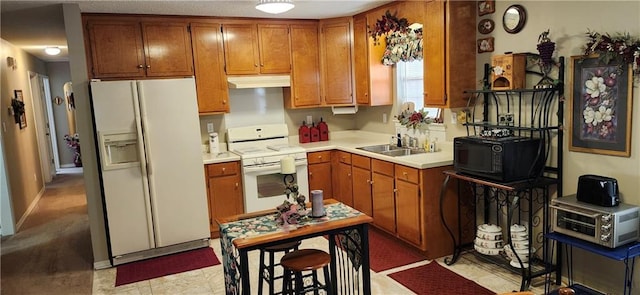 kitchen featuring white appliances and sink