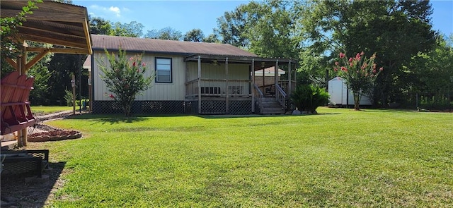 view of yard with a porch and a storage shed