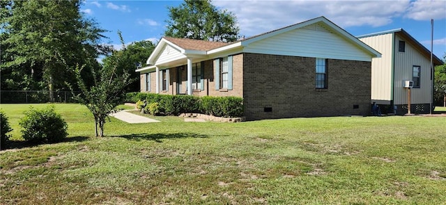 view of side of home featuring a lawn and a porch