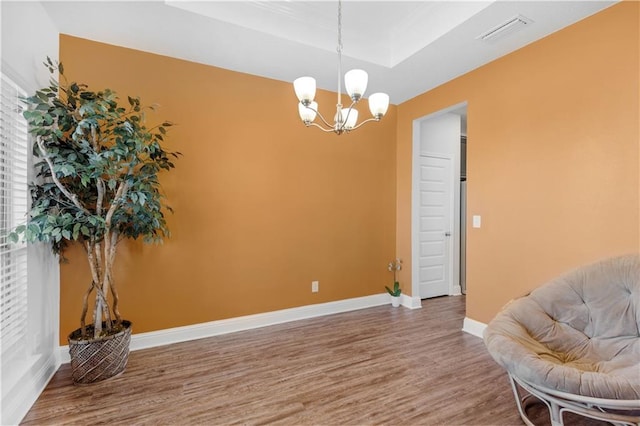 living area featuring a chandelier and hardwood / wood-style floors