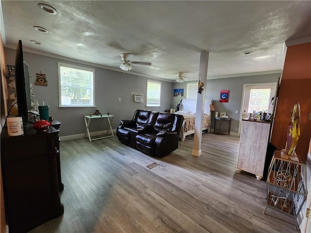 8560 Sadie Ct, Grand Bay, AL 36541 - living area with wood finished floors, a textured ceiling, crown molding, healthy amount of natural light, and ceiling fan