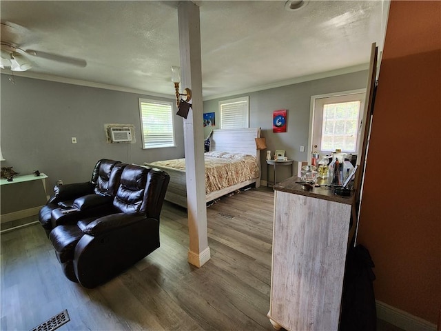 8560 Sadie Ct, Grand Bay, AL 36541 - bedroom with ornamental molding, wood finished floors, a wall mounted AC, and a ceiling fan