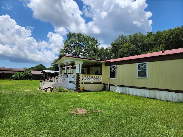 8560 Sadie Ct, Grand Bay, AL 36541 - view of front facade featuring a front lawn, a metal roof, and a porch