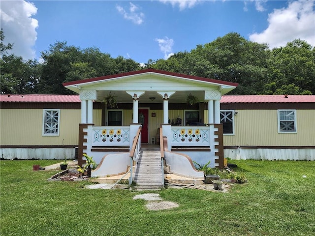 8560 Sadie Ct, Grand Bay, AL 36541 - view of front of home with covered porch, a front yard, and a metal roof