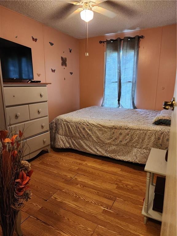 8560 Sadie Ct, Grand Bay, AL 36541 - bedroom with a textured ceiling, wood finished floors, and ceiling fan