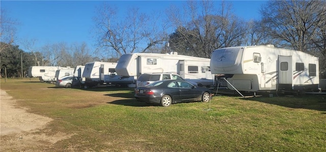 exterior space with uncovered parking and a front lawn