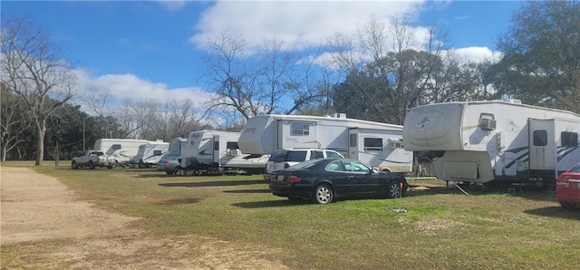 view of car parking with a lawn