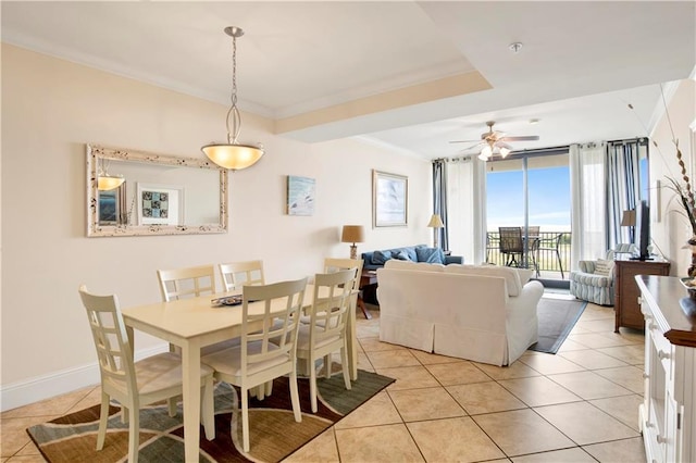 tiled dining area featuring ornamental molding and ceiling fan