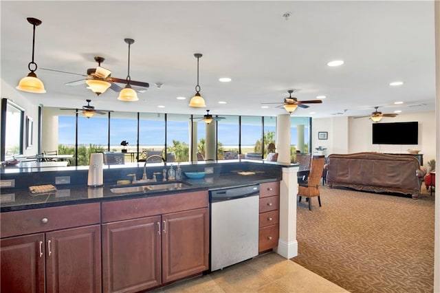 kitchen featuring stainless steel dishwasher, ceiling fan, sink, and decorative light fixtures