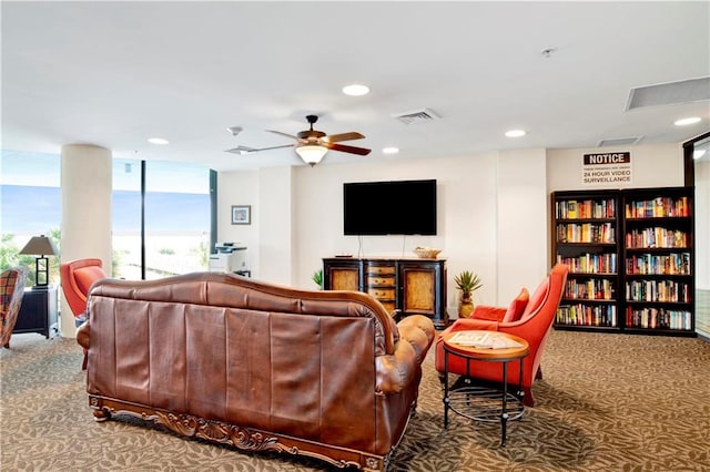 carpeted living room featuring ceiling fan