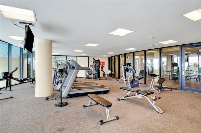 gym with floor to ceiling windows and carpet flooring