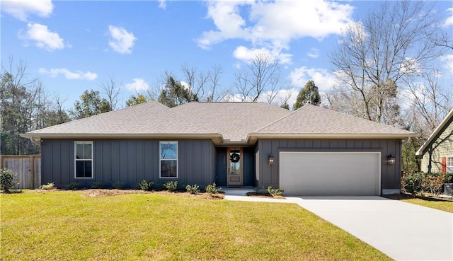 325 Pecan Ridge Blvd, Fairhope, AL 36532 - ranch-style house featuring concrete driveway, a front yard, board and batten siding, and a garage