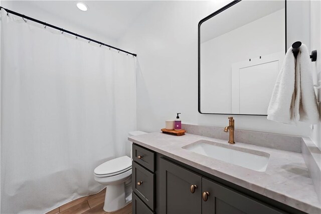 325 Pecan Ridge Blvd, Fairhope, AL 36532 - bathroom with toilet, vanity, and wood finished floors