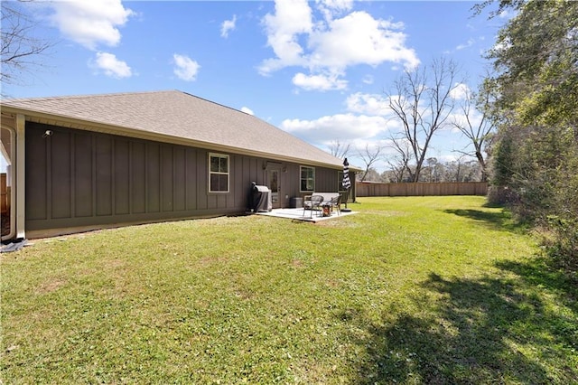 325 Pecan Ridge Blvd, Fairhope, AL 36532 - back of house with board and batten siding, a patio area, a lawn, and fence