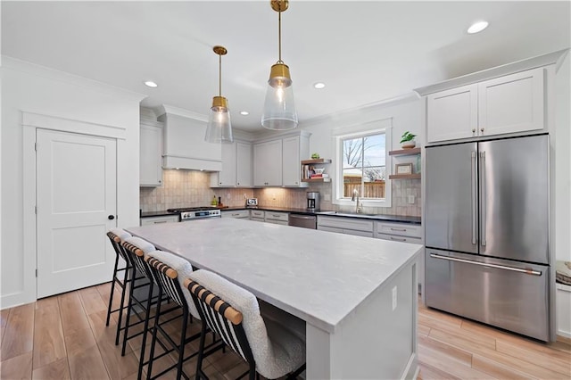 325 Pecan Ridge Blvd, Fairhope, AL 36532 - kitchen featuring stainless steel appliances, a sink, light wood-type flooring, open shelves, and ornamental molding