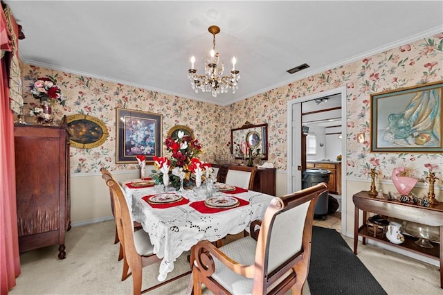 dining space with crown molding, light colored carpet, and a chandelier