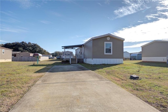 view of side of home with a yard and covered porch