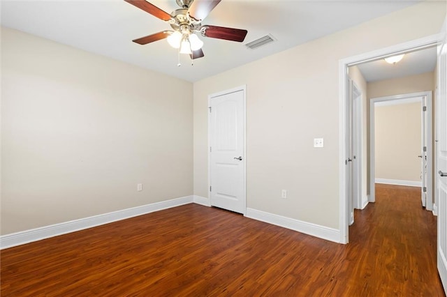 unfurnished bedroom with dark hardwood / wood-style flooring and ceiling fan