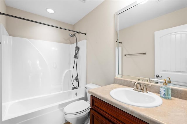 full bathroom featuring washtub / shower combination, vanity, and toilet