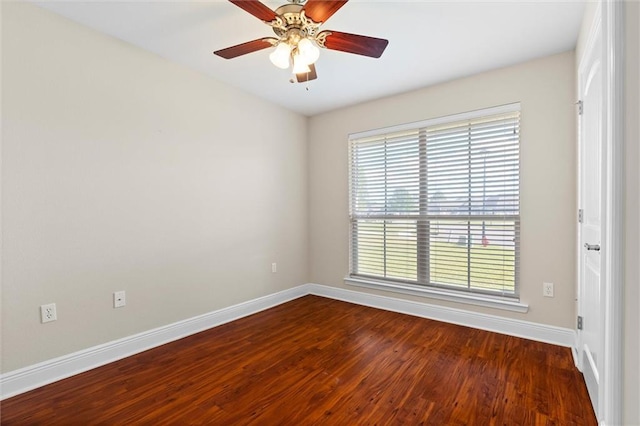 empty room featuring ceiling fan and dark wood-type flooring