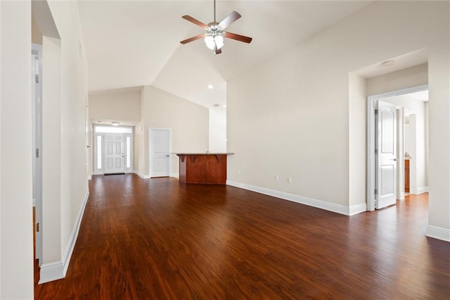 unfurnished living room with ceiling fan, dark hardwood / wood-style floors, and lofted ceiling