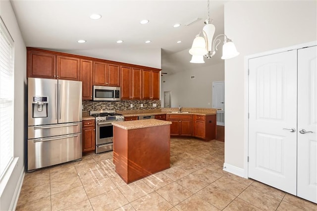 kitchen with sink, hanging light fixtures, kitchen peninsula, stainless steel appliances, and a chandelier