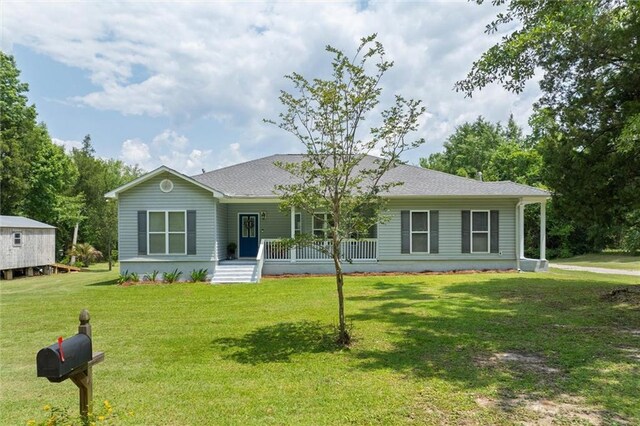 218 Ferry Ave, Saraland, AL 36571 - single story home featuring covered porch, a front yard, and a shingled roof