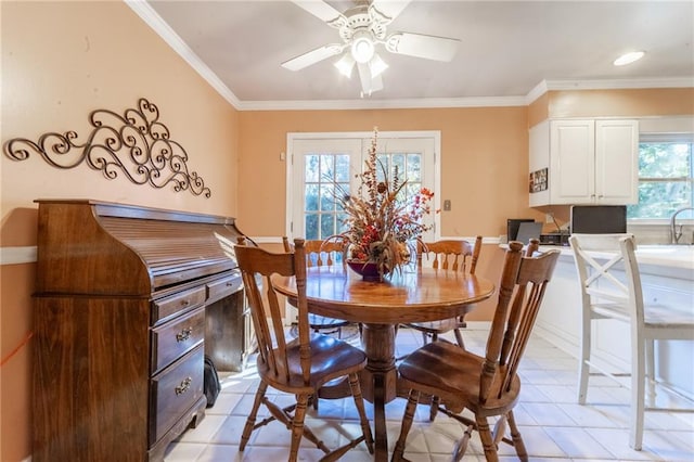 dining space featuring a wealth of natural light, light tile patterned floors, and crown molding