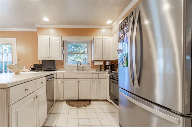 kitchen with white cabinetry, stainless steel appliances, light tile patterned flooring, a wealth of natural light, and sink