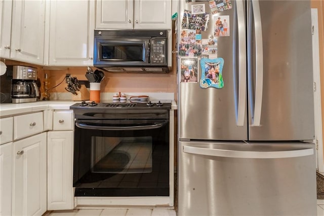 kitchen featuring white cabinets and black appliances