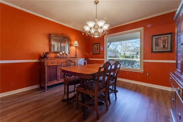 dining room featuring ornamental molding, a chandelier, and dark hardwood / wood-style floors