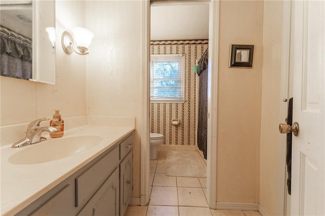 bathroom with tile patterned floors, vanity, toilet, and walk in shower