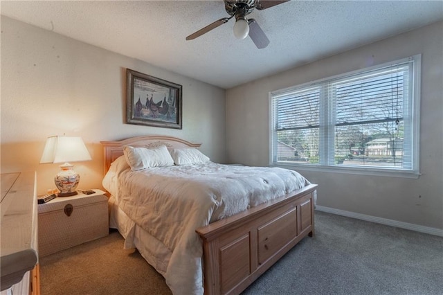 bedroom featuring ceiling fan, a textured ceiling, and carpet flooring