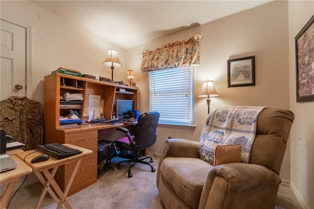 carpeted home office with lofted ceiling and a textured ceiling