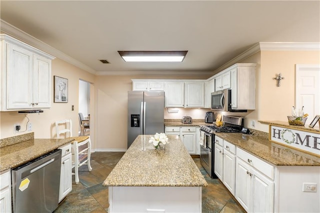 10164 Waterford Way, Mobile, AL 36695 - kitchen with stainless steel appliances, crown molding, dark stone finish flooring, white cabinets, and light stone counters