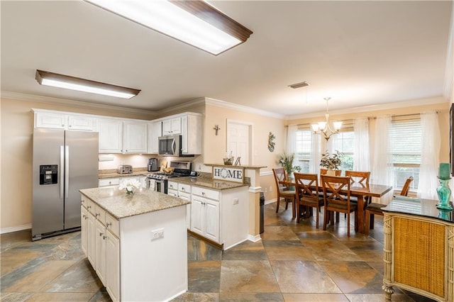 10164 Waterford Way, Mobile, AL 36695 - kitchen featuring appliances with stainless steel finishes, dark stone finish floors, white cabinetry, and ornamental molding