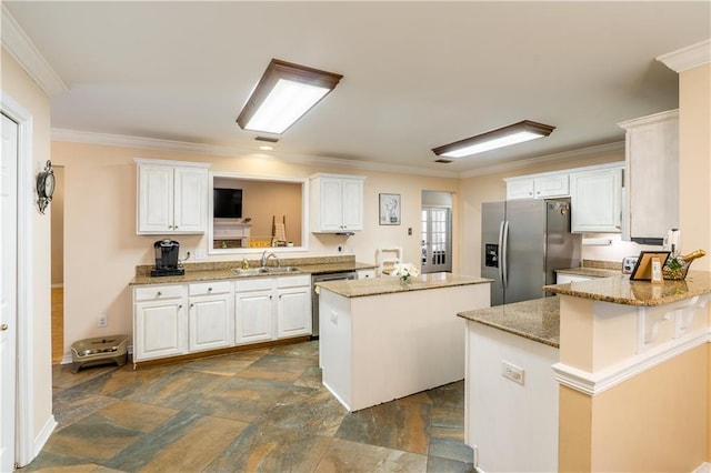 10164 Waterford Way, Mobile, AL 36695 - kitchen featuring stainless steel appliances, a kitchen island, dark stone finish floors, white cabinets, and crown molding